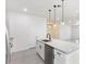 Modern kitchen with white cabinets, granite counters, and stainless steel appliances at 1305 Congo Ct, Poinciana, FL 34759