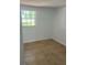 Simple bedroom with neutral walls and tile flooring at 5580 W State Road 542 W, Winter Haven, FL 33880