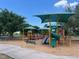 Community playground with shaded areas and play equipment for  at 5580 W State Road 542 W, Winter Haven, FL 33880