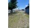 Side yard with a grassy area and wooden fence at 5580 W State Road 542 W, Winter Haven, FL 33880