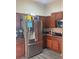 Kitchen with stainless steel refrigerator and ample wood cabinetry at 1910 Nw 85Th Loop, Ocala, FL 34475