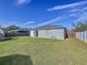 Spacious backyard with grassy lawn, wooden fence, and shed at 1621 Saddlehorn Dr, Lakeland, FL 33810