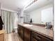 Clean bathroom with a shower/tub combo, vanity, and updated flooring at 1621 Saddlehorn Dr, Lakeland, FL 33810
