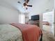 Spacious bedroom with a large bed, dresser, and ceiling fan at 1621 Saddlehorn Dr, Lakeland, FL 33810
