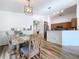 Kitchen and dining area with hardwood floors, wooden table, and a breakfast bar at 1621 Saddlehorn Dr, Lakeland, FL 33810
