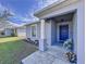 Inviting front porch with a blue door and white columns at 1621 Saddlehorn Dr, Lakeland, FL 33810