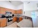 Modern kitchen with stainless steel appliances and wood cabinets at 1621 Saddlehorn Dr, Lakeland, FL 33810