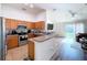 Modern kitchen with stainless steel appliances and wood cabinets at 1621 Saddlehorn Dr, Lakeland, FL 33810
