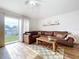 Spacious living room with a brown leather sectional sofa and wood coffee table at 1621 Saddlehorn Dr, Lakeland, FL 33810