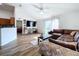 Living room with leather sectional, hardwood floors, and sliding glass doors to backyard at 1621 Saddlehorn Dr, Lakeland, FL 33810
