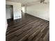 Spacious living area featuring dark laminate wood floors at 3709 Blarney Dr, Orlando, FL 32808