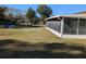 Backyard with screened porch and grassy area at 2150 Ne 54Th St, Ocala, FL 34479