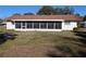 Backyard view of the house with a screened porch at 2150 Ne 54Th St, Ocala, FL 34479
