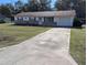 Brick ranch house with a large yard and long driveway at 2150 Ne 54Th St, Ocala, FL 34479