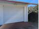 White garage door with red concrete flooring at 2150 Ne 54Th St, Ocala, FL 34479