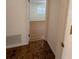 View down a hallway with wood-look laminate flooring at 2150 Ne 54Th St, Ocala, FL 34479