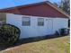 Red and white house exterior with a white door and air conditioning unit at 2150 Ne 54Th St, Ocala, FL 34479