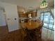 Kitchen and dining area with wood cabinets, tiled floor, and a sliding glass door at 2150 Ne 54Th St, Ocala, FL 34479