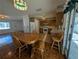 Kitchen and dining area with wood cabinets, tiled floor, and access to outdoor space at 2150 Ne 54Th St, Ocala, FL 34479