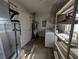 Interior laundry room with washer, dryer, and storage shelves at 2150 Ne 54Th St, Ocala, FL 34479