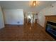 Living room with tiled floor, fireplace, and view into dining area and kitchen at 2150 Ne 54Th St, Ocala, FL 34479