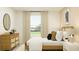 Bedroom with light wood bed frame, dresser, and neutral tones at 776 Osprey Roost Dr, Lakeland, FL 33801