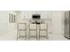 Bright kitchen features white cabinets and a breakfast bar with three stools at 776 Osprey Roost Dr, Lakeland, FL 33801