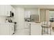 Modern kitchen with white cabinets, island, and stainless steel appliances at 776 Osprey Roost Dr, Lakeland, FL 33801