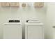 Laundry room with washer, dryer, and shelving at 776 Osprey Roost Dr, Lakeland, FL 33801