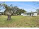 Spacious backyard with mature trees and a detached building at 9210 Lehall W Sq, Lakeland, FL 33810