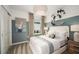 Bright bedroom with a comfortable bed and coastal-themed decor at 9076 Wildlight Trl, Wildwood, FL 34785