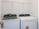 Laundry room featuring a washer and dryer with wire shelving above at 9076 Wildlight Trl, Wildwood, FL 34785