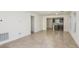 Open-concept living room with tile floors leading into the kitchen featuring an island and stainless steel appliances at 9076 Wildlight Trl, Wildwood, FL 34785