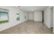 Expansive living room with tiled floors, natural light, and neutral color palette at 9076 Wildlight Trl, Wildwood, FL 34785