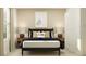 Bedroom with beige walls, bed, and nightstands with minimalist decor at 3467 Howell Dr, Lake Wales, FL 33859