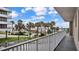 Balcony overlooking palm trees and partial ocean view at 3737 S Atlantic Ave # 204, Daytona Beach Shores, FL 32118