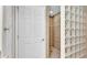 Shower with glass block wall and tiled floors at 3737 S Atlantic Ave # 204, Daytona Beach Shores, FL 32118