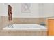Relaxing bathtub with tile surround, perfect for soaking at 3737 S Atlantic Ave # 204, Daytona Beach Shores, FL 32118