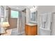 Clean bathroom with shower/tub combo, wood vanity, and granite countertop at 3737 S Atlantic Ave # 204, Daytona Beach Shores, FL 32118