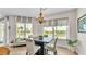 Dining area with a table for four and large windows at 3737 S Atlantic Ave # 204, Daytona Beach Shores, FL 32118