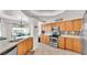 Kitchen with granite countertops, stainless steel appliances, and light wood cabinets at 3737 S Atlantic Ave # 204, Daytona Beach Shores, FL 32118