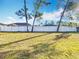 Large backyard with grassy area and white vinyl fence at 16962 Sw 40Th Cir, Ocala, FL 34473