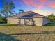 Tan house exterior with sliding glass doors and grassy yard at 16962 Sw 40Th Cir, Ocala, FL 34473