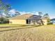 Tan house exterior with sliding glass doors and grassy yard at 16962 Sw 40Th Cir, Ocala, FL 34473