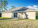 Tan house exterior with sliding glass doors and grassy yard at 16962 Sw 40Th Cir, Ocala, FL 34473