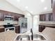 Kitchen features dark wood cabinets and a double sink at 16962 Sw 40Th Cir, Ocala, FL 34473
