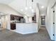 Modern kitchen with dark wood cabinetry and a breakfast bar at 16962 Sw 40Th Cir, Ocala, FL 34473