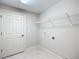 Bright laundry room with built-in shelving and access to a full bathroom at 16962 Sw 40Th Cir, Ocala, FL 34473