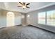 Living room with gray carpet, large window, and interior view at 16962 Sw 40Th Cir, Ocala, FL 34473