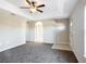 Open living area with gray carpet and ceiling fan at 16962 Sw 40Th Cir, Ocala, FL 34473